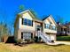 Charming two-story home featuring a brick facade, yellow siding, and a welcoming staircase to the front door at 4962 Newpark Nw Ln, Acworth, GA 30101