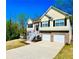 Inviting two-story home with a spacious driveway, showcasing a blend of siding and brick architecture at 4962 Newpark Nw Ln, Acworth, GA 30101