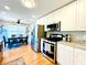 Modern kitchen equipped with stainless steel appliances, sleek cabinetry, and hardwood floors, seamlessly connecting to the dining area at 4962 Newpark Nw Ln, Acworth, GA 30101