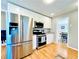 Contemporary kitchen features stainless steel appliances, ample cabinet space, and seamless access to the adjacent dining room at 4962 Newpark Nw Ln, Acworth, GA 30101