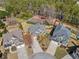 Aerial perspective of homes with large driveways and backyards, showcasing the neighborhood's layout and landscaping at 548 Lawton Bridge Sw Rd, Smyrna, GA 30082