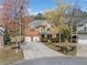 Aerial view of a brick and tan home, showcasing the surrounding neighborhood and landscaping, including a long driveway at 548 Lawton Bridge Sw Rd, Smyrna, GA 30082