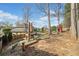 Spacious backyard featuring a built-in grill, playset and mature trees at 548 Lawton Bridge Sw Rd, Smyrna, GA 30082