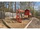 Backyard area with playhouse, swings, and wooden border at 548 Lawton Bridge Sw Rd, Smyrna, GA 30082