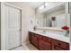 Well-lit bathroom vanity with a large mirror, wood cabinets, and stylish decor at 548 Lawton Bridge Sw Rd, Smyrna, GA 30082