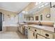 Bathroom with large mirror, double sinks, shower and bathtub with beige tile at 548 Lawton Bridge Sw Rd, Smyrna, GA 30082