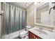 Bright bathroom with a clear shower curtain, a wooden vanity, and a large mirror at 548 Lawton Bridge Sw Rd, Smyrna, GA 30082