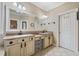 Bathroom with large mirror, double sinks, and beige tile at 548 Lawton Bridge Sw Rd, Smyrna, GA 30082