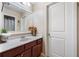 Bathroom featuring wood cabinets, granite countertop, and decorative accents at 548 Lawton Bridge Sw Rd, Smyrna, GA 30082