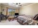 Comfortable bedroom featuring a ceiling fan, a desk, and a large window offering natural light at 548 Lawton Bridge Sw Rd, Smyrna, GA 30082