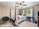 Charming bedroom with four-poster bed, ceiling fan and study area with a window view at 548 Lawton Bridge Sw Rd, Smyrna, GA 30082