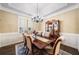Formal dining room with wainscoting, chandelier, a large table with seating for six, and an elegant china cabinet at 548 Lawton Bridge Sw Rd, Smyrna, GA 30082