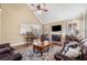 Living room featuring a fireplace, ceiling fan, hardwood floors, and pass through to kitchen at 548 Lawton Bridge Sw Rd, Smyrna, GA 30082
