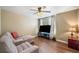Living room featuring hardwood floors, ceiling fan, a sectional couch, and a TV at 548 Lawton Bridge Sw Rd, Smyrna, GA 30082