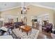 Open-concept living room with hardwood floors, fireplace, and views of the kitchen and dining area at 548 Lawton Bridge Sw Rd, Smyrna, GA 30082