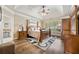 Spacious bedroom with decorative ceiling, hardwood floors, ceiling fan, and a decorative rug at 548 Lawton Bridge Sw Rd, Smyrna, GA 30082