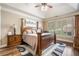 Spacious bedroom with decorative ceiling, hardwood floors, ceiling fan, and a decorative rug at 548 Lawton Bridge Sw Rd, Smyrna, GA 30082
