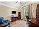 Cozy office with hardwood floors, built-in shelves, a work desk, and a large window offering ample natural light at 548 Lawton Bridge Sw Rd, Smyrna, GA 30082