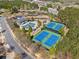 Aerial shot featuring community amenities including tennis courts, a playground, and pool surrounded by lush trees at 548 Lawton Bridge Sw Rd, Smyrna, GA 30082