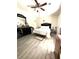Cozy bedroom featuring a ceiling fan, nice flooring, and a large black dresser with a mirror at 5687 Pine Meadow Ct, Morrow, GA 30260