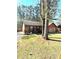 Cozy single-story home with a covered porch and beautiful natural light filtering through the trees at 5687 Pine Meadow Ct, Morrow, GA 30260