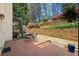 A backyard featuring a brick patio, a grill, and tiered landscaping at 2376 Massey Ln, Decatur, GA 30033
