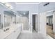 A spacious bathroom featuring a glass-enclosed shower, double vanity sinks, and light-filled space at 2376 Massey Ln, Decatur, GA 30033