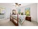 Cozy bedroom with two windows, a ceiling fan, an ensuite bathroom, and classic furniture at 2376 Massey Ln, Decatur, GA 30033