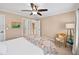 Inviting bedroom featuring a ceiling fan, a rattan chair, large windows, and calming decor at 2376 Massey Ln, Decatur, GA 30033