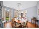Elegant dining room featuring a chandelier, hardwood floors, and views of the backyard at 2376 Massey Ln, Decatur, GA 30033