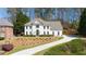Elegant home showcasing a well-maintained lawn, a curved driveway, and mature trees at 2376 Massey Ln, Decatur, GA 30033