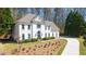 Front view of an elegant white home with manicured front yard and a curved driveway at 2376 Massey Ln, Decatur, GA 30033