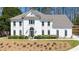 Stately two-story home featuring a white exterior, manicured landscaping, and an inviting entrance at 2376 Massey Ln, Decatur, GA 30033