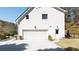 Three car garage featuring a level driveway and walkway to side door at 2376 Massey Ln, Decatur, GA 30033