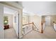 Bright hallway with a staircase and a view of a bedroom through an open doorway at 2376 Massey Ln, Decatur, GA 30033