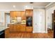 Kitchen featuring wooden cabinets, granite countertops, and modern appliances, including built-in oven at 2376 Massey Ln, Decatur, GA 30033