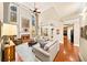 Inviting living space with tall windows, a fireplace, and a view of the kitchen at 2376 Massey Ln, Decatur, GA 30033