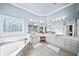 Bright bathroom with dual vanity sinks, soaking tub, and decorative window at 2376 Massey Ln, Decatur, GA 30033