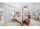 Bright main bedroom with decorative ceiling, four-poster bed, and natural light at 2376 Massey Ln, Decatur, GA 30033