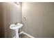 Powder room features a pedestal sink, decorative mirror and updated faucet at 258 Venture Path, Hiram, GA 30141