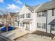 Exterior view of a well-maintained two-story townhome with neutral siding and dark shutters at 258 Venture Path, Hiram, GA 30141