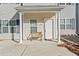 Inviting front porch featuring white columns, new front door, and a wooden bench at 258 Venture Path, Hiram, GA 30141