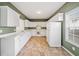 Eat-in kitchen with bright windows, white cabinetry, and a full suite of appliances at 258 Venture Path, Hiram, GA 30141