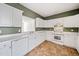 Kitchen with white cabinets, countertops, matching appliances and tiled floor at 258 Venture Path, Hiram, GA 30141