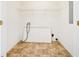 Bright laundry room featuring tile floors, a storage shelf, and washer/dryer hookups at 258 Venture Path, Hiram, GA 30141