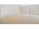 Large living area with plush carpeting, and two entryways to other rooms in the home at 258 Venture Path, Hiram, GA 30141