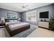 Well-lit main bedroom features large windows, ceiling fan and decorative lighting at 258 Venture Path, Hiram, GA 30141