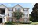 Charming condo building featuring brick and siding accents, complemented by a well-maintained lawn and mature trees at 5204 Waldrop, Decatur, GA 30034
