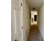 Hallway with tan carpet leading to another room at 5204 Waldrop, Decatur, GA 30034