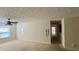 Bright living room featuring neutral walls and carpet, ceiling fan, and a view into the hall at 5204 Waldrop, Decatur, GA 30034
